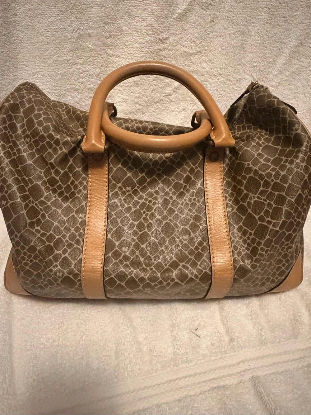 Nina Ricci Brown Patterned Duffel with Tan Trim. Has lock and key.